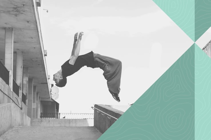 Black-and-white photo of a man doing parkour with a jump in the air. Superimposed on this is a colorful graphic element, symbolizing two arrows that meet at the top, inspiring precision.